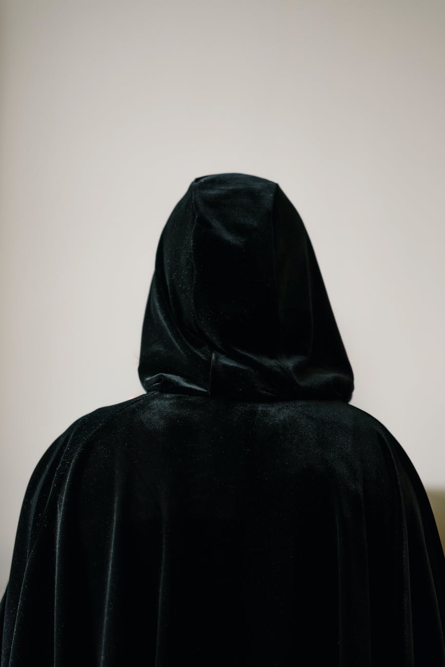 person in black cloak